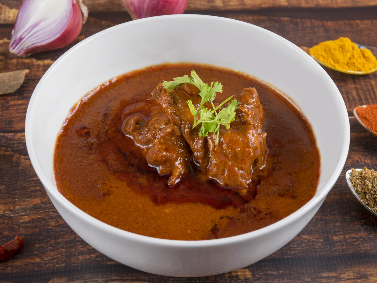 Laal Maans Baati Choorma — fiery Rajasthani mutton curry with baked wheat rolls and sweet choorma
