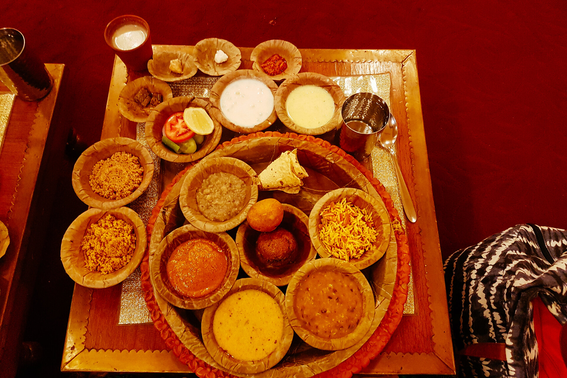 An elaborate Rajasthani thali platter with an array of curries, dal, roti and accompaniments on a silver plate